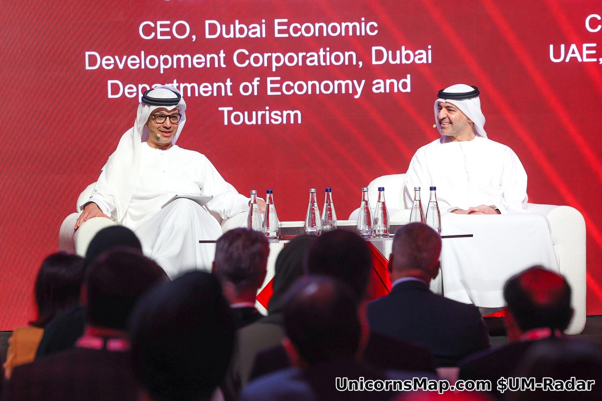 HE Hadi Badri and Mohamed Al Marzooqi in armchairs on the summit stage, the LED wall behind them reading CEO, Dubai Economic Development Corporation, Dubai Department of Economy and Tourism