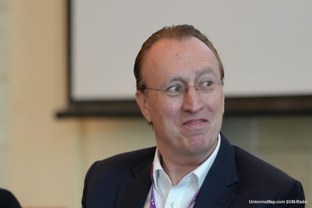 Hubbis Middle East Private Capital Forum 2026 — a speaker in session in front of the room's projection screen, Hubbis lanyard worn