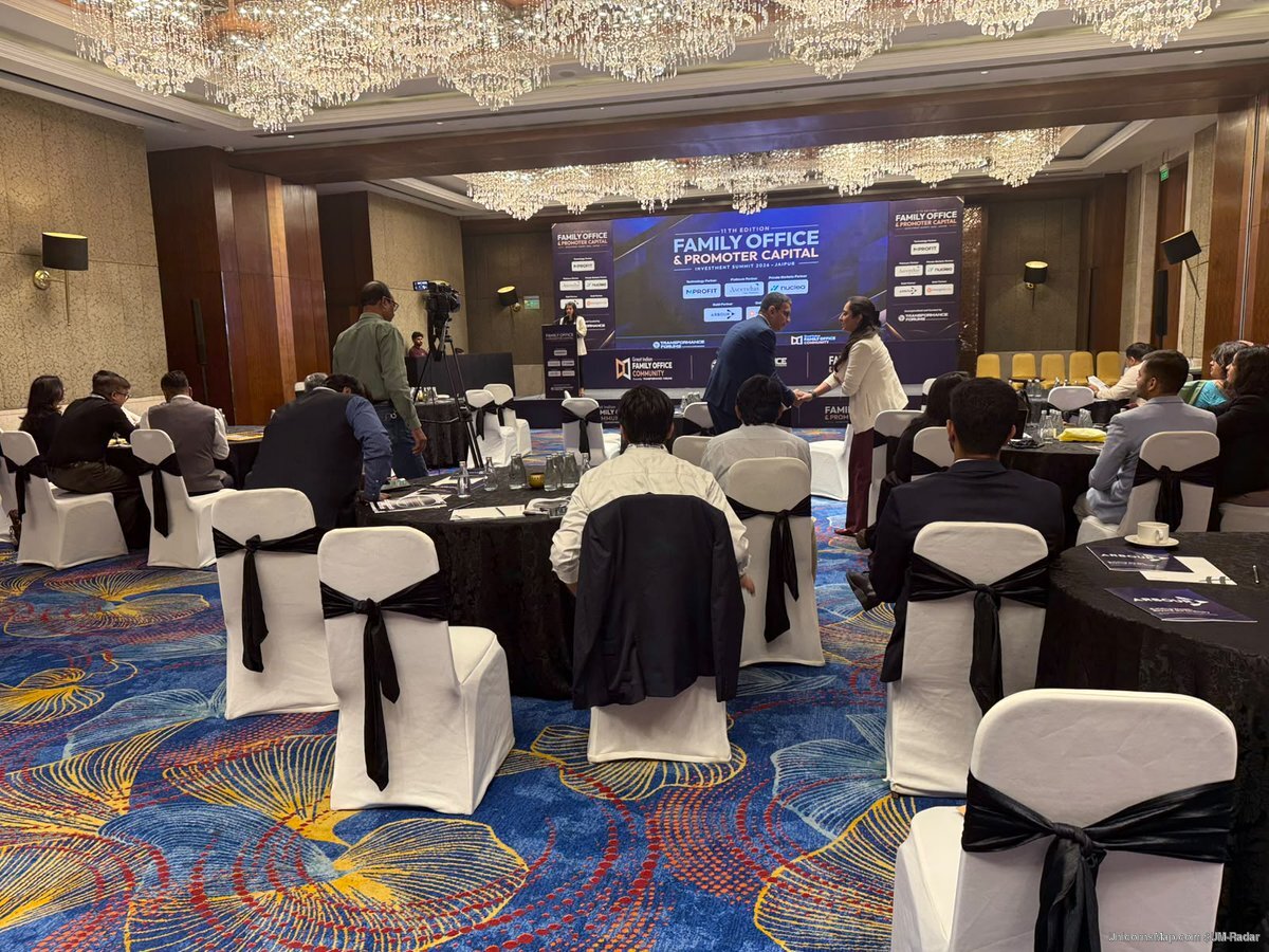 Ballroom of the Jaipur summit with the LED stage, sponsor wall and delegate tables
