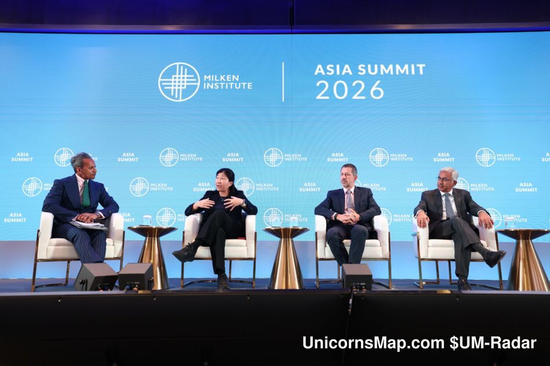 Milken Institute Asia Summit 2026 — four-seat stage panel under the event's ASIA SUMMIT 2026 backdrop: the 'Investing Through Global Disruption' Global Overview Part 2 session, Four Seasons Hotel Singapore