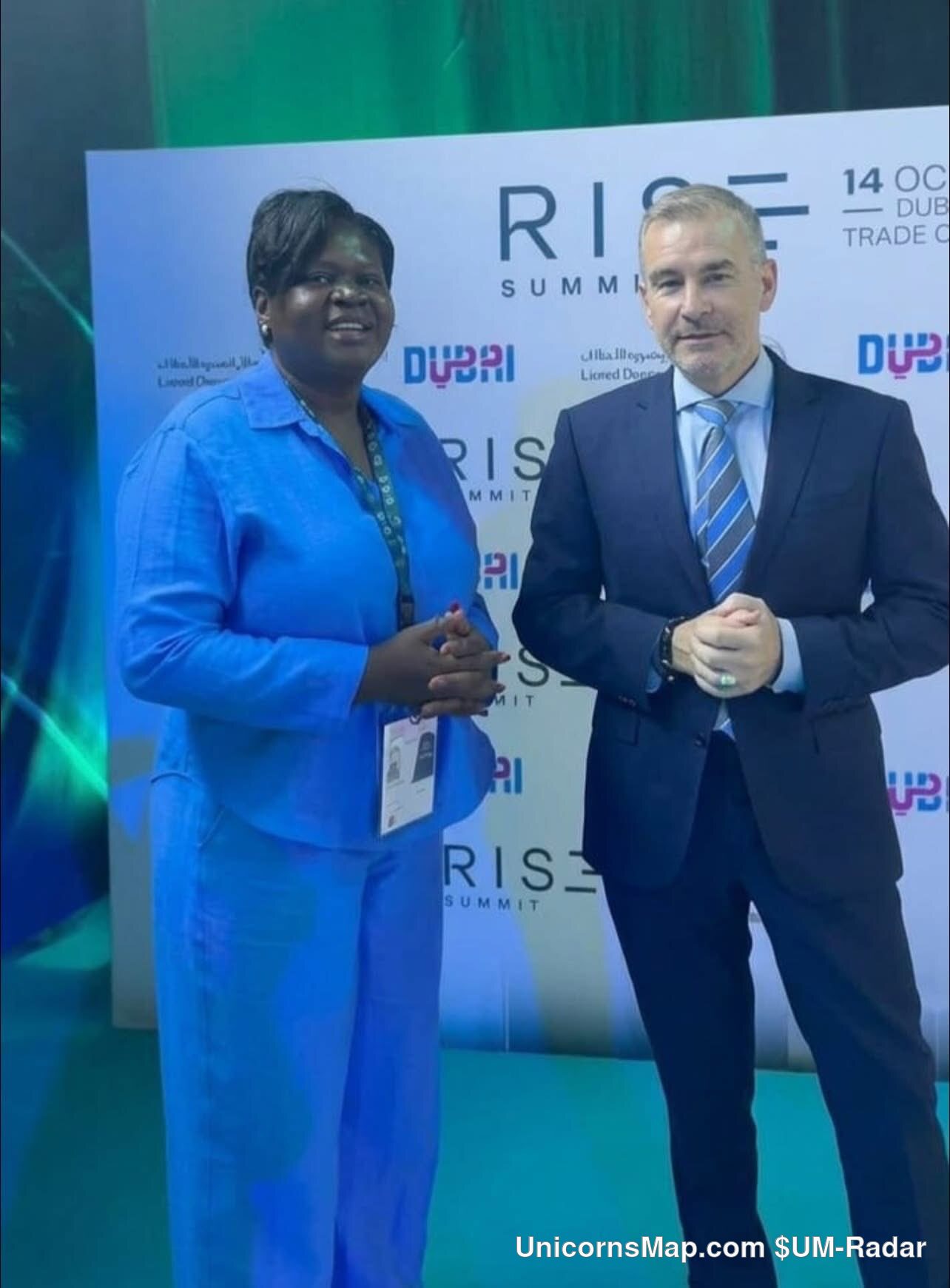 RISE Summit 2026 - two delegates at the event's own RISE SUMMIT / 14 OCT / DUBAI TRADE CENTRE backdrop