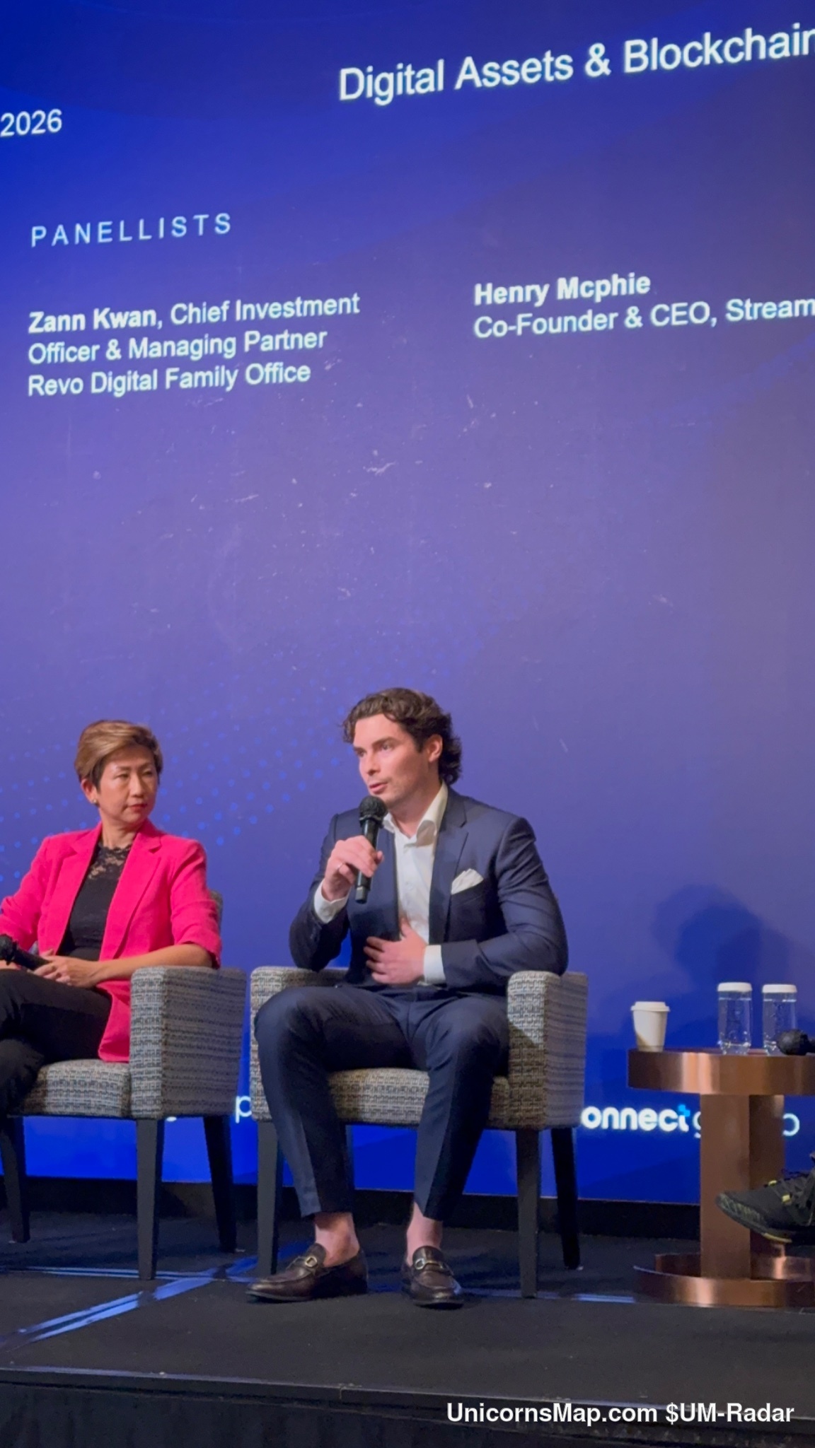 World Family Office Forum | Asia 2026 — closer stage frame of the Digital Assets & Blockchain panel under the forum's own LED wall, The Ritz-Carlton, Hong Kong, 15 October 2026