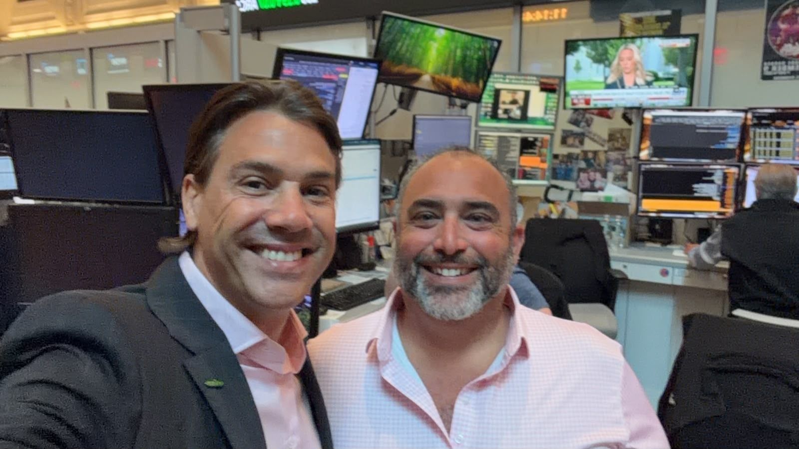 Yoni Assia at the NYSE / TradeZero booth with the CNBC desk behind
